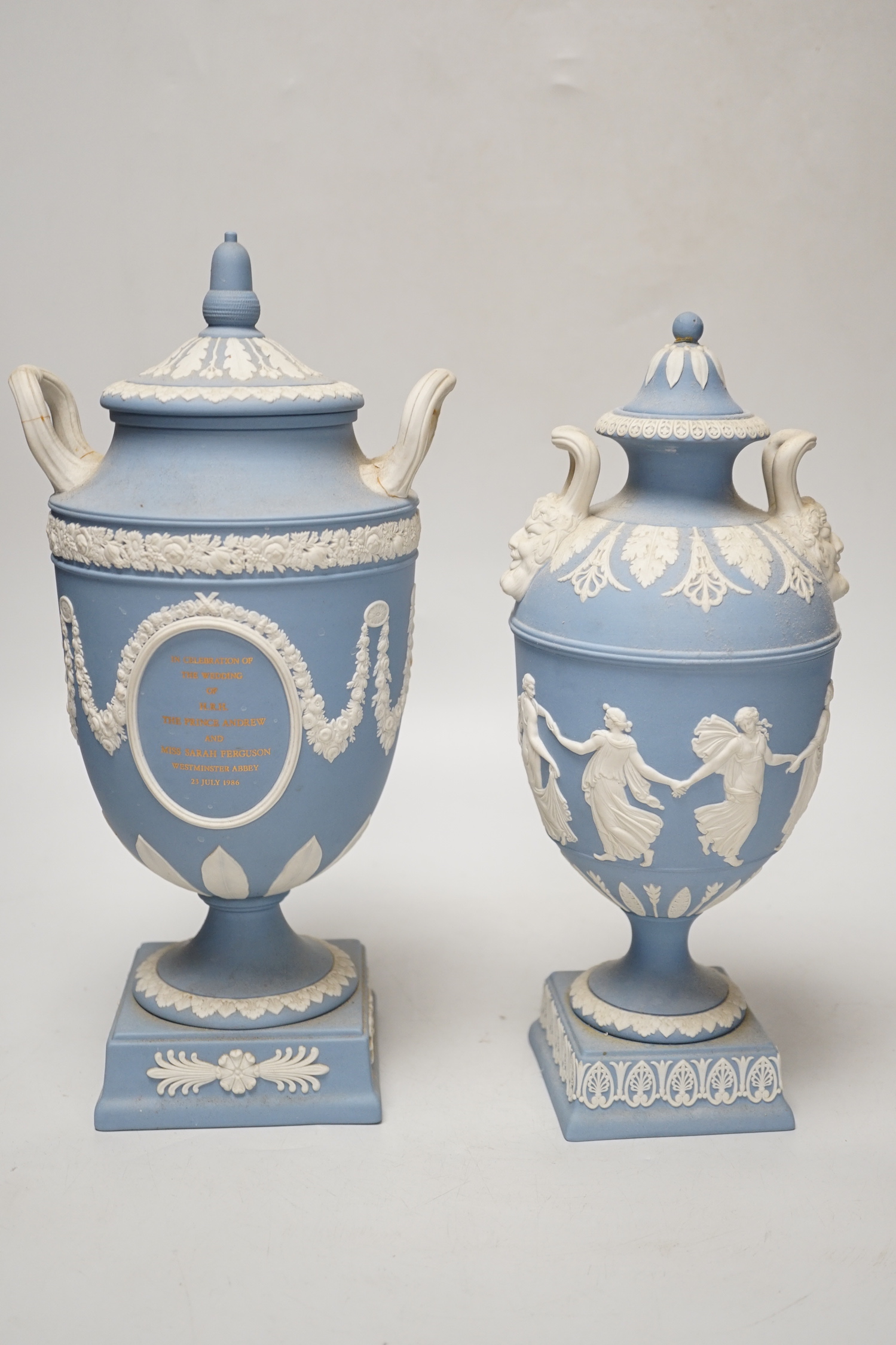 A Wedgwood blue jasper commemorative urn and cover and a similar smaller urn and cover, tallest 31cm